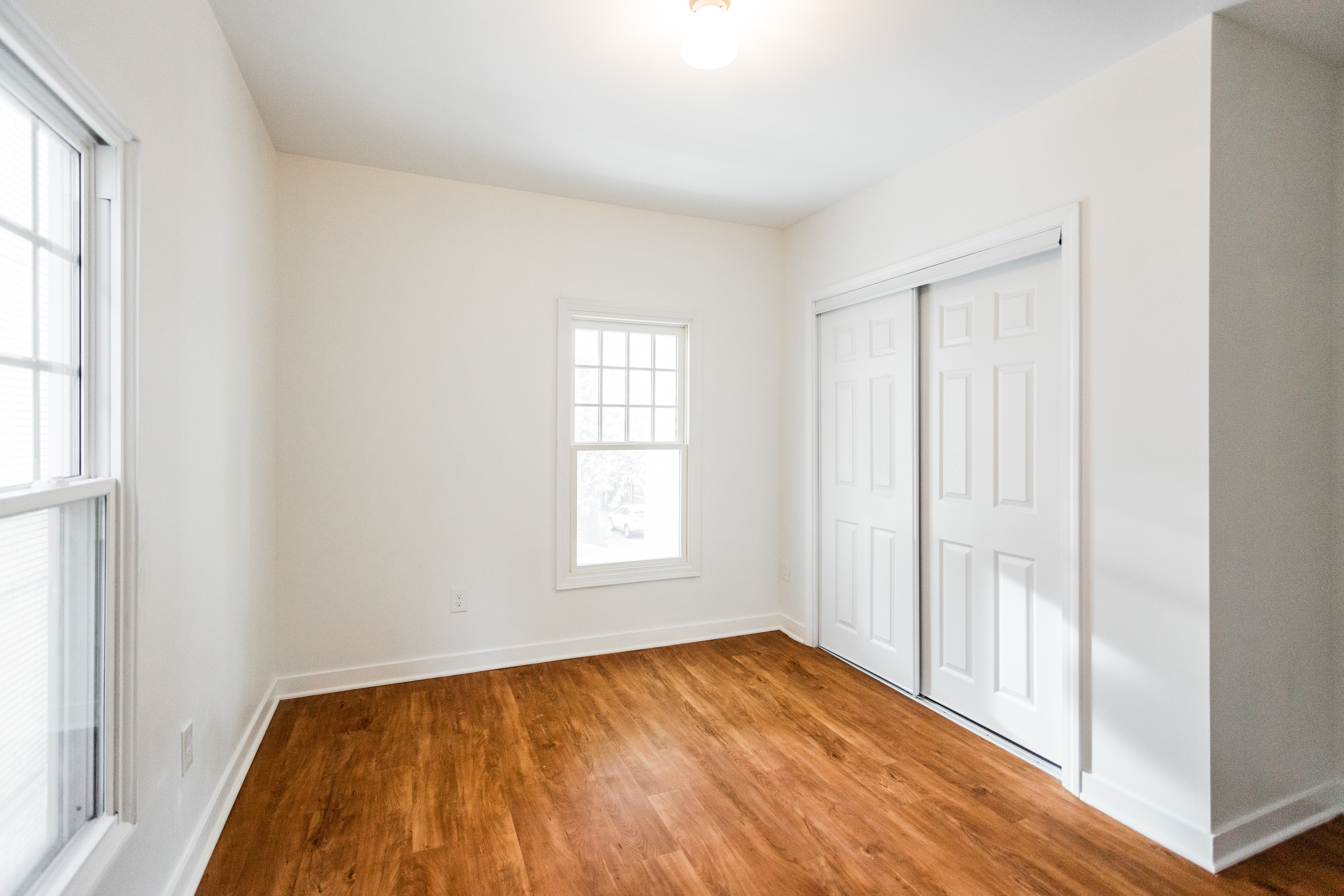 A room with a wooden floor and white walls.